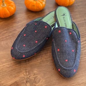 Blue denim loafers with red dots.